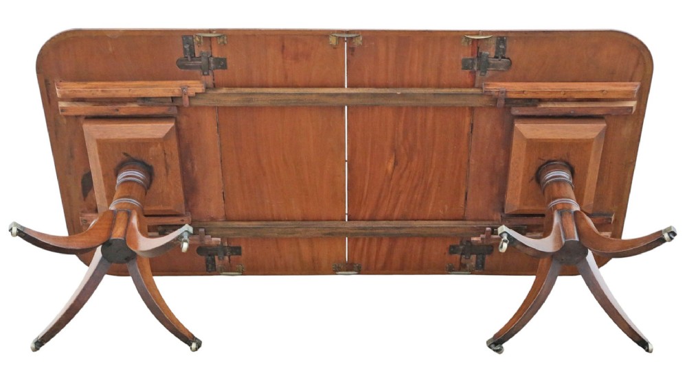 A 19th-century mahogany twin pedestal extending dining table with rounded corners, reeded edge detailing, and brass castors. View IX