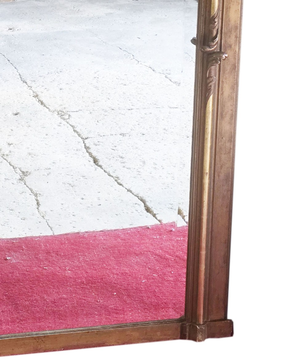 A tall 19th-century gilded overmantel mirror featuring an arched frame, top cresting, and molded lattice frieze. View IV