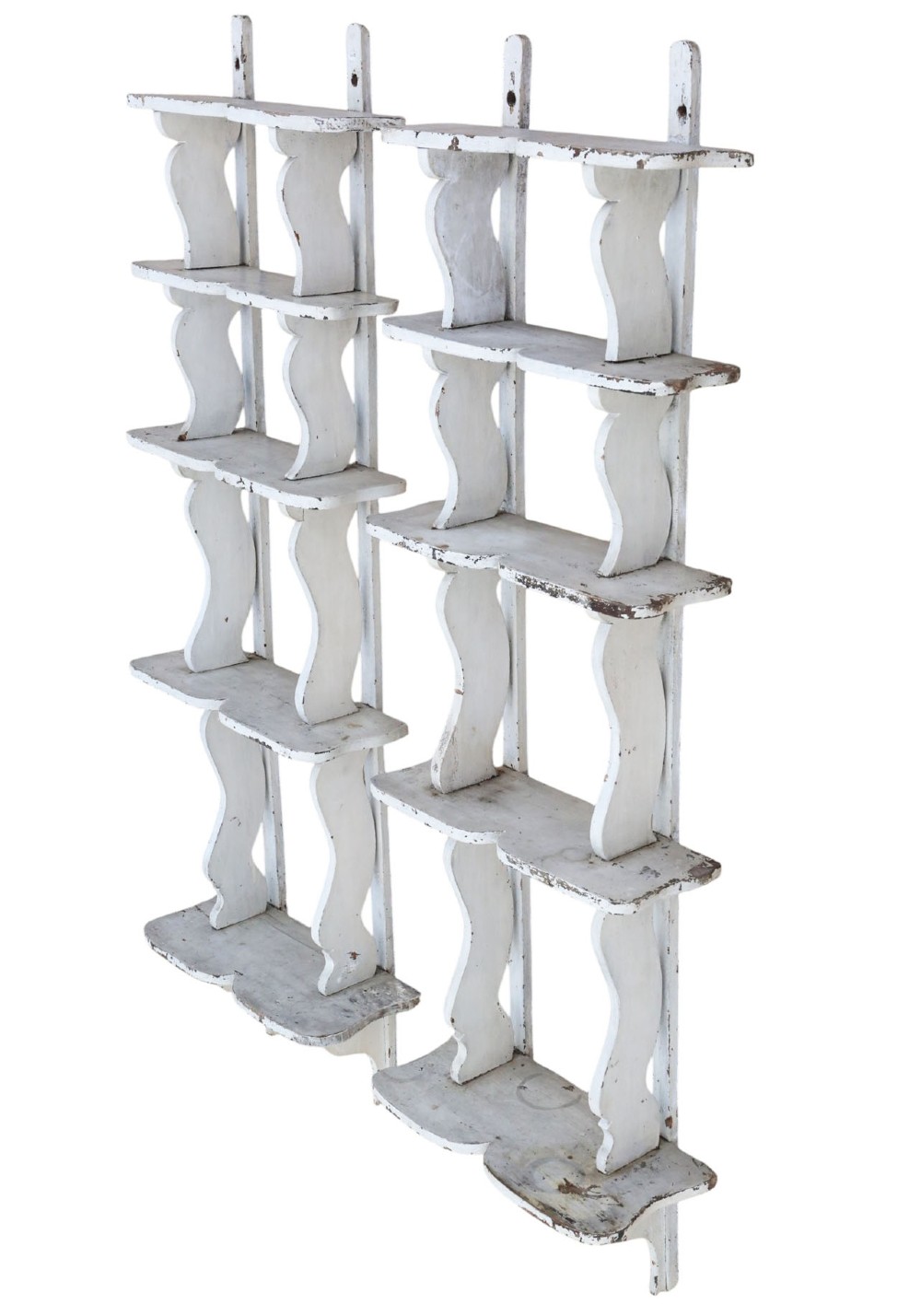 A pair of 19th-century wall-mounted wooden shelves featuring five tiers with shaped, curved upright supports in a distressed white painted finish.