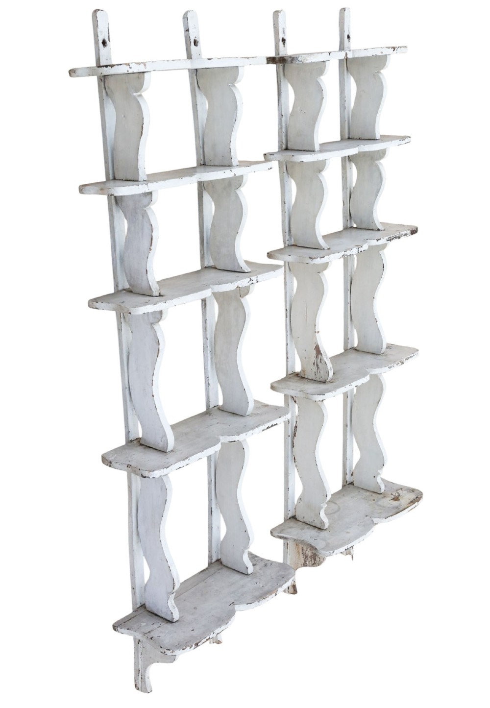 A pair of 19th-century wall-mounted wooden shelves featuring five tiers with shaped, curved upright supports in a distressed white painted finish. View II