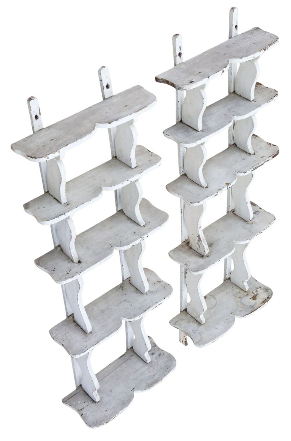 A pair of 19th-century wall-mounted wooden shelves featuring five tiers with shaped, curved upright supports in a distressed white painted finish. View V