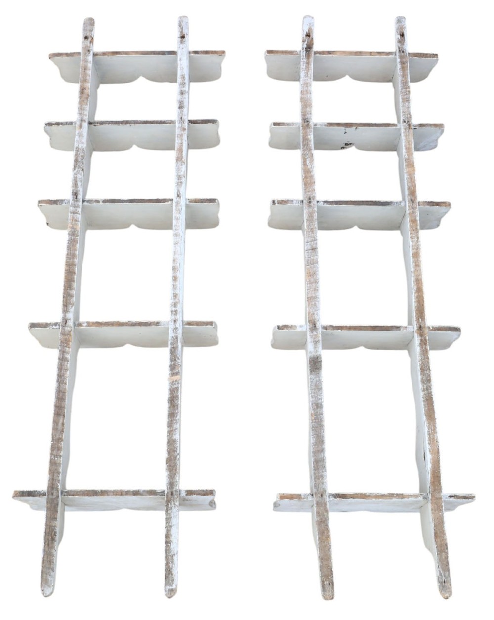 A pair of 19th-century wall-mounted wooden shelves featuring five tiers with shaped, curved upright supports in a distressed white painted finish. View VII