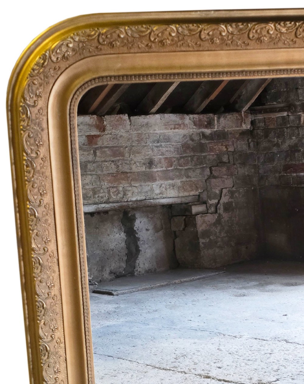 A large late nineteenth-century rectangular overmantel mirror with rounded upper corners, an intricate foliate carved gilt frame, and a beaded inner border. View II