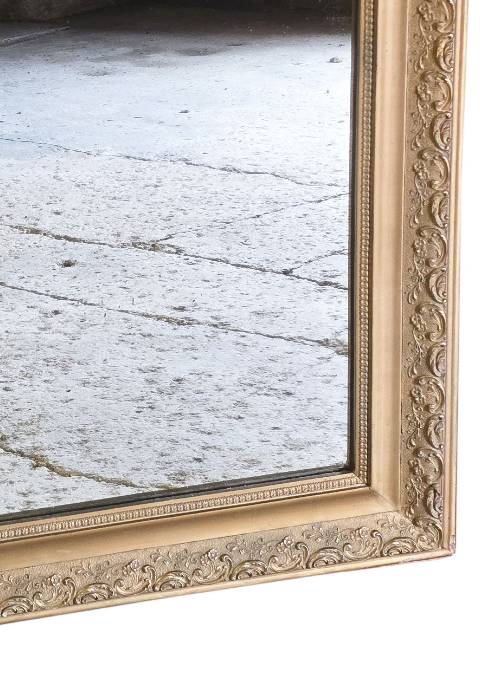 A large late nineteenth-century rectangular overmantel mirror with rounded upper corners, an intricate foliate carved gilt frame, and a beaded inner border. View IV