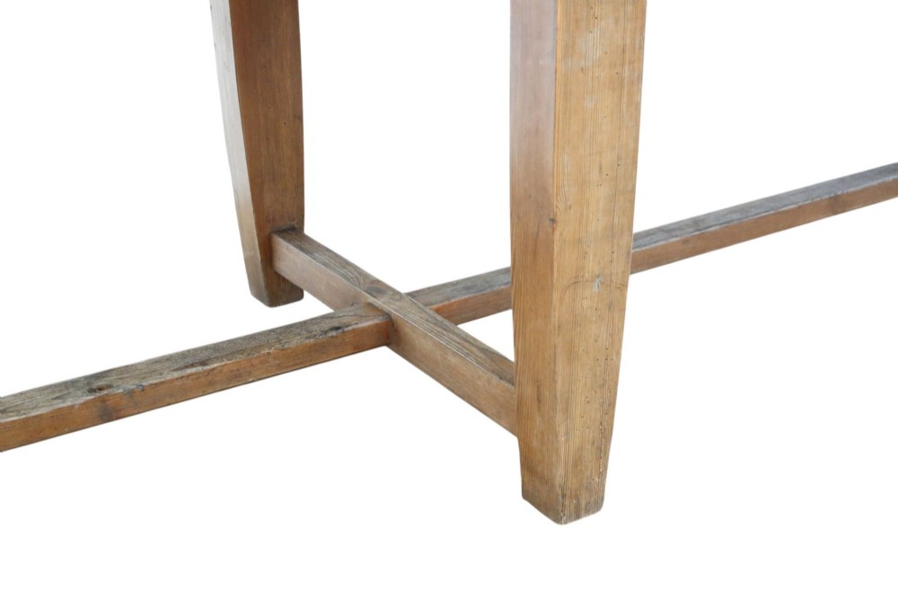 A long 19th-century pine refectory dining table featuring a three-plank top, six tapered square legs, and an H-stretcher base. View X
