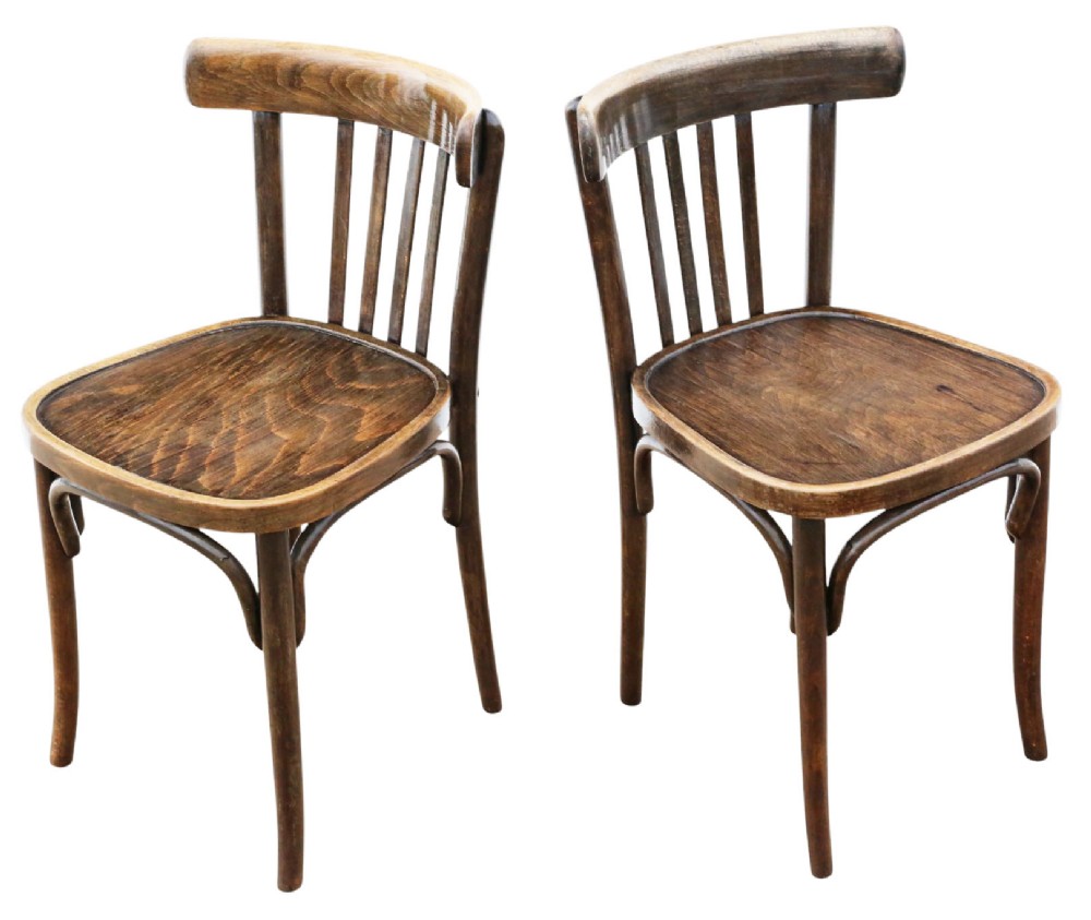 A pair of dark brown bentwood bistro dining chairs featuring vertical back spindles, steam-bent frames, and contoured wood seats. View II