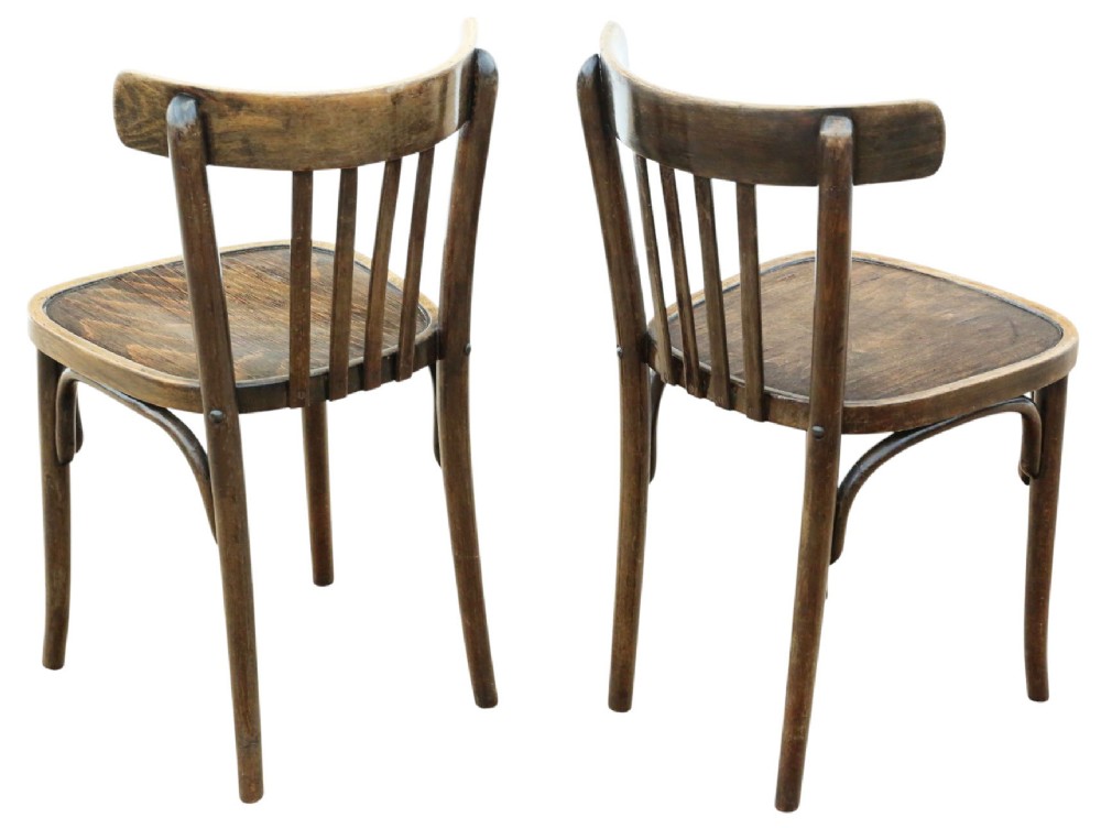 A pair of dark brown bentwood bistro dining chairs featuring vertical back spindles, steam-bent frames, and contoured wood seats. View III
