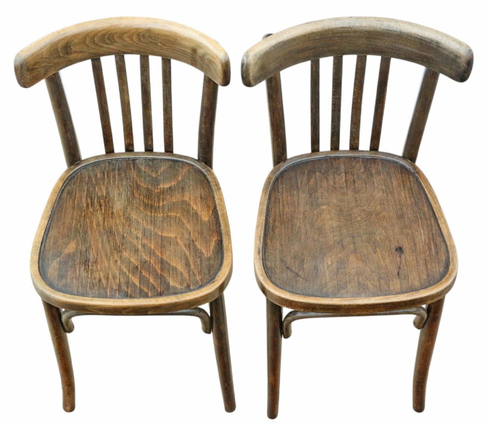 A pair of dark brown bentwood bistro dining chairs featuring vertical back spindles, steam-bent frames, and contoured wood seats. View IV