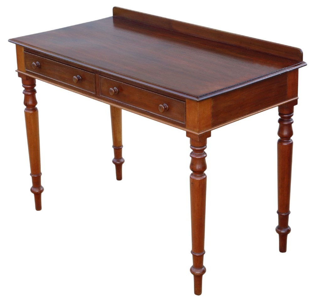 A 19th-century mahogany writing and dressing table featuring two frieze drawers with turned handles, a low gallery back, and tapered turned legs.