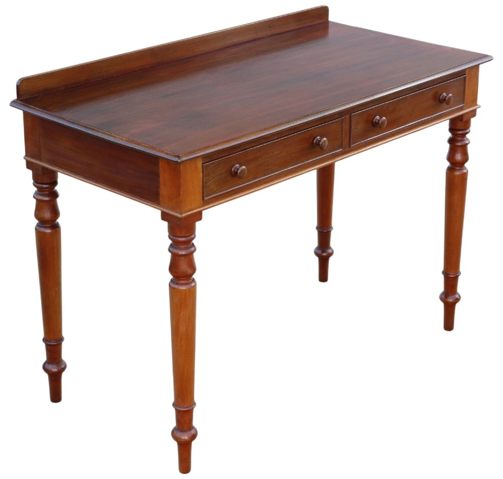 A 19th-century mahogany writing and dressing table featuring two frieze drawers with turned handles, a low gallery back, and tapered turned legs. View VII