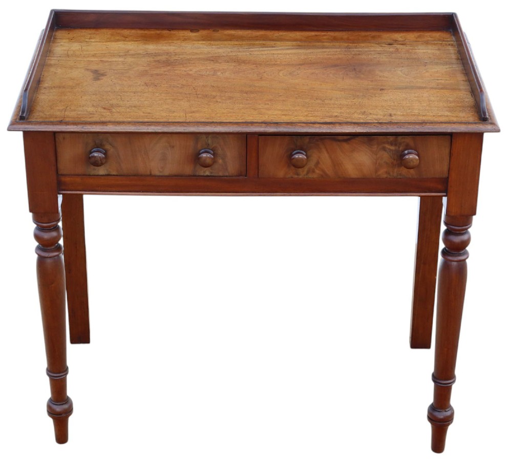 A 19th-century mahogany writing table featuring a gallery top, two frieze drawers with wooden knob handles, and turned legs.