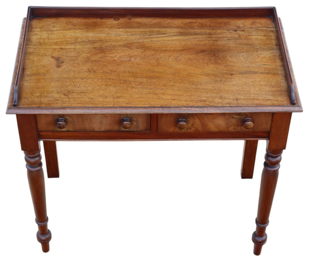 A 19th-century mahogany writing table featuring a gallery top, two frieze drawers with wooden knob handles, and turned legs. View II