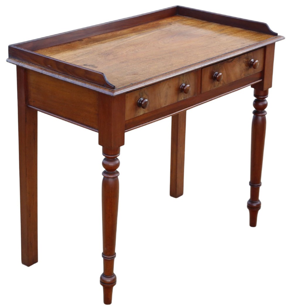 A 19th-century mahogany writing table featuring a gallery top, two frieze drawers with wooden knob handles, and turned legs. View V