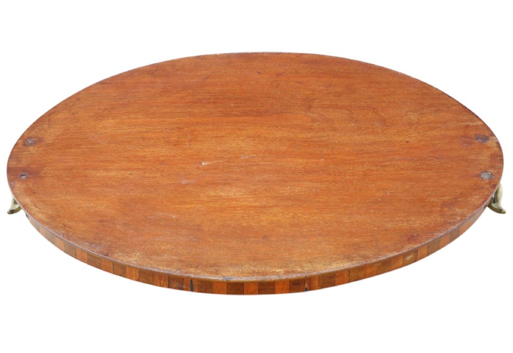 An oval mahogany serving tray decorated with floral marquetry inlay and fitted with twin brass handles. View V