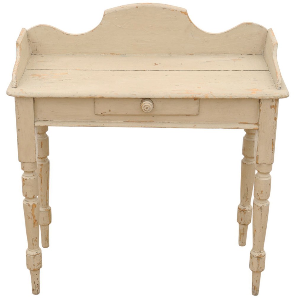 A 19th-century cream painted wooden writing table featuring a shaped gallery back, turned legs, and a single central drawer with a turned wooden knob.