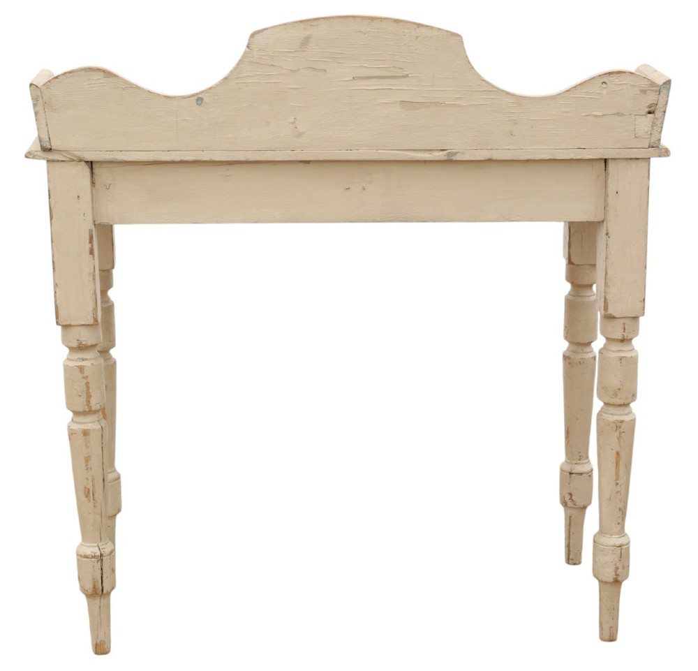 A 19th-century cream painted wooden writing table featuring a shaped gallery back, turned legs, and a single central drawer with a turned wooden knob. View VII