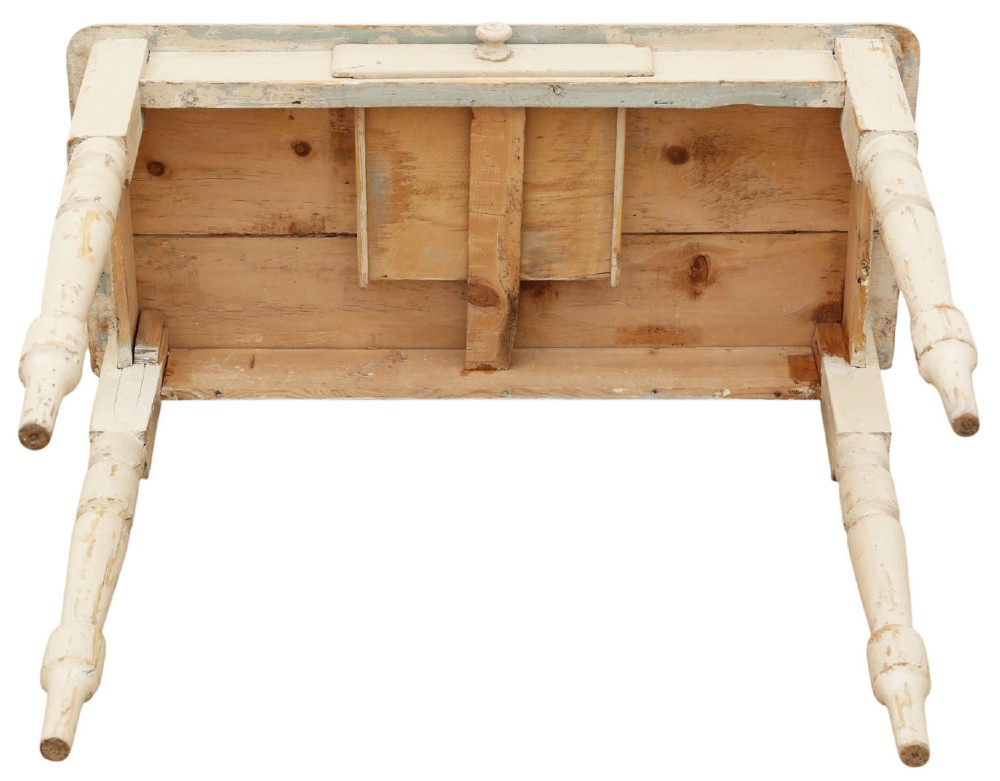 A 19th-century cream painted wooden writing table featuring a shaped gallery back, turned legs, and a single central drawer with a turned wooden knob. View VIII