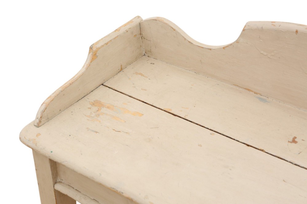 A 19th-century cream painted wooden writing table featuring a shaped gallery back, turned legs, and a single central drawer with a turned wooden knob. View X
