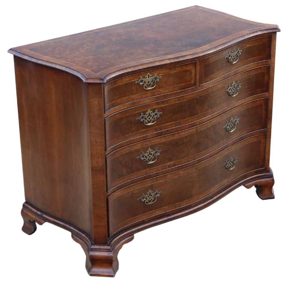 A serpentine-front burr walnut chest of drawers featuring crossbanded borders, cast brass handles, and ogee bracket feet.