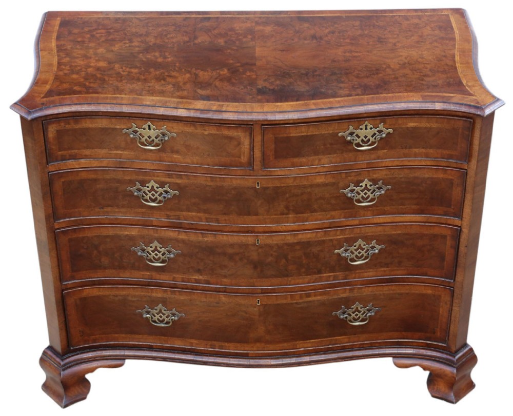 A serpentine-front burr walnut chest of drawers featuring crossbanded borders, cast brass handles, and ogee bracket feet. View II