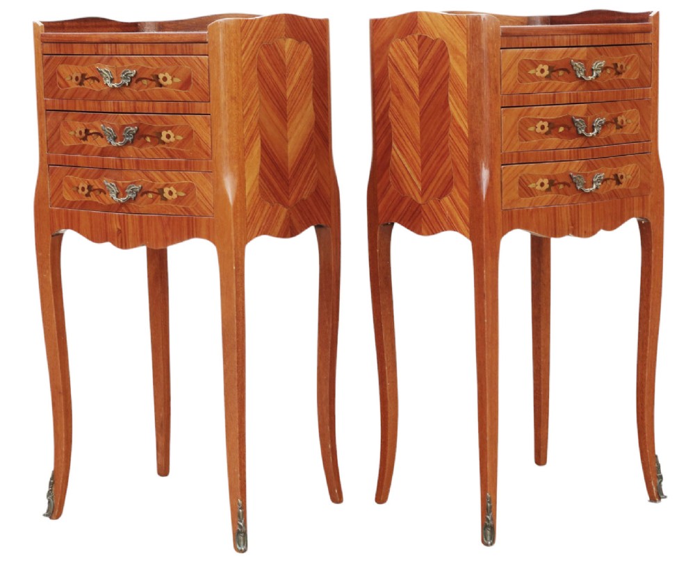 A pair of slim French style bedside tables featuring floral marquetry wood inlays, three drawers with brass handles, and slender cabriole legs. View V