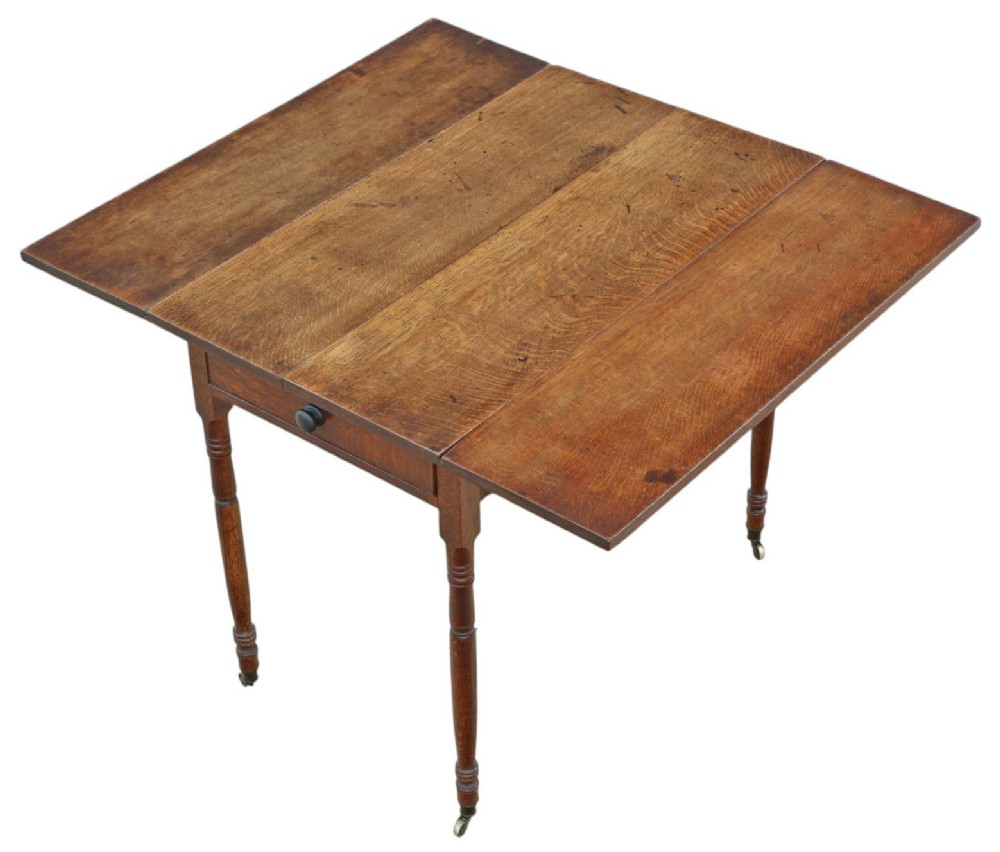 A Georgian oak drop-leaf Pembroke table featuring turned legs, a single end drawer, and brass castors. View II