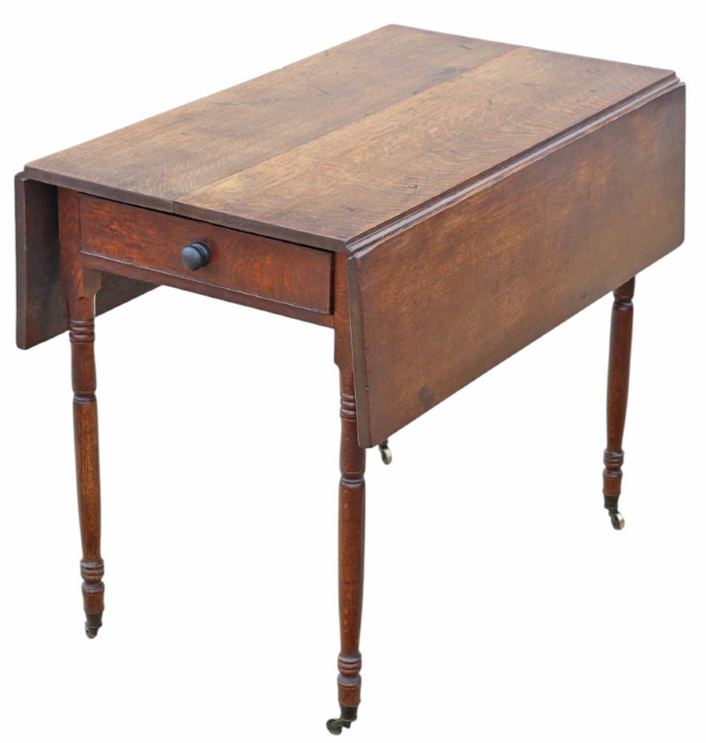 A Georgian oak drop-leaf Pembroke table featuring turned legs, a single end drawer, and brass castors. View VII