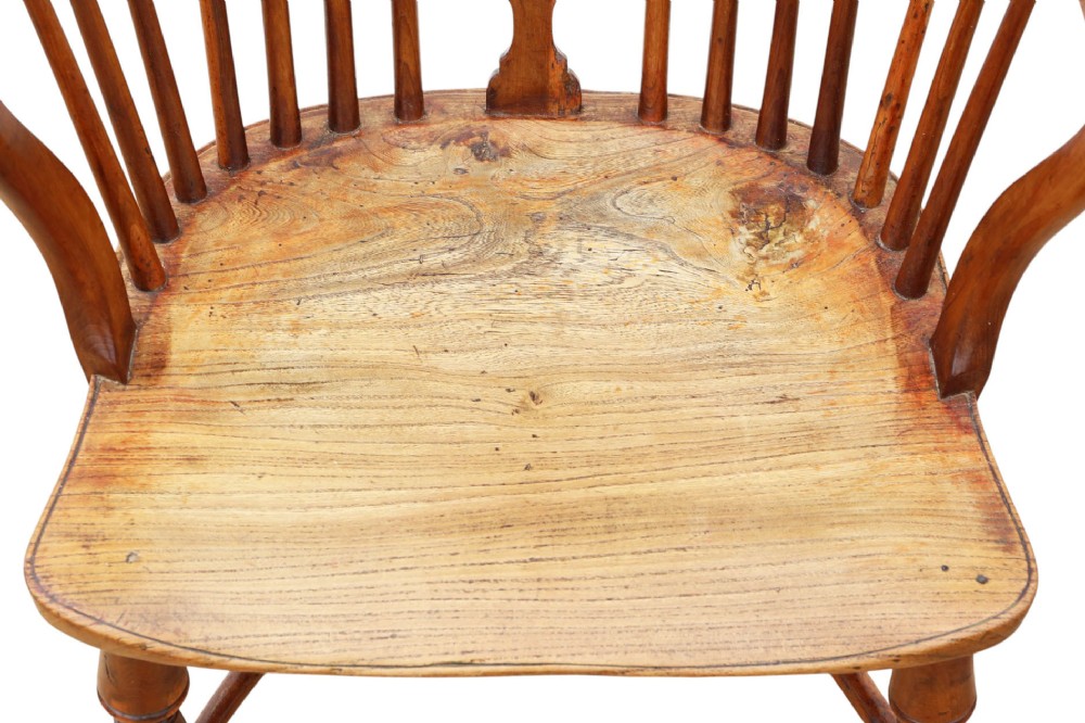 A 19th-century yew and elm Windsor armchair featuring a hoop back, pierced central splat, turned legs, and a crinoline stretcher. View V