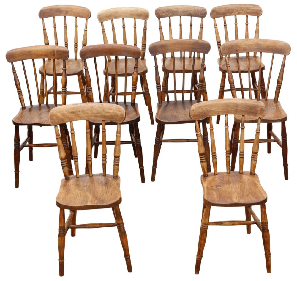 A harlequin set of ten 19th-century Victorian dining chairs crafted from elm and beech wood, featuring spindle backs, curved top rails, turned legs, and stretchers.