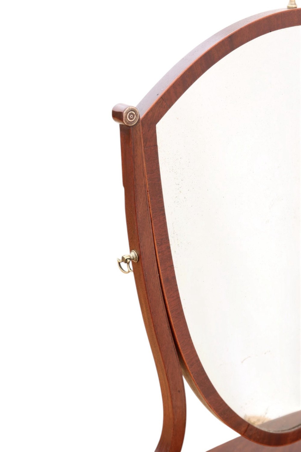 A 19th-century Georgian mahogany swing mirror featuring a shield-shaped frame supported by curved uprights over a shaped base with three small drawers. View II