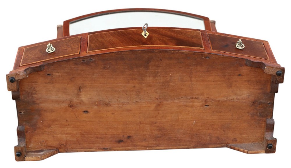 A 19th-century Georgian mahogany swing mirror featuring a shield-shaped frame supported by curved uprights over a shaped base with three small drawers. View VI