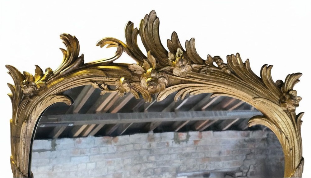 A large 19th-century tall wall mirror featuring an ornate gilded wood frame with hand-carved acanthus leaf cresting and scrollwork. View III
