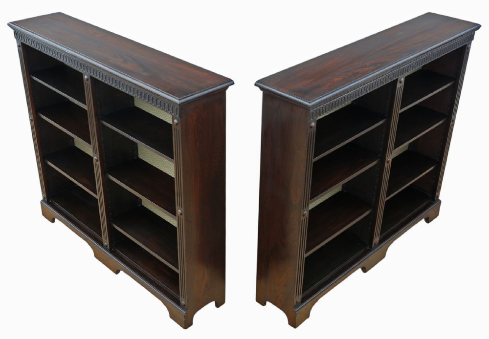 A matching pair of dark oak double-bay bookcases featuring fluted vertical trim, adjustable shelving, green pattern-lined interiors, and bracket bases. View III