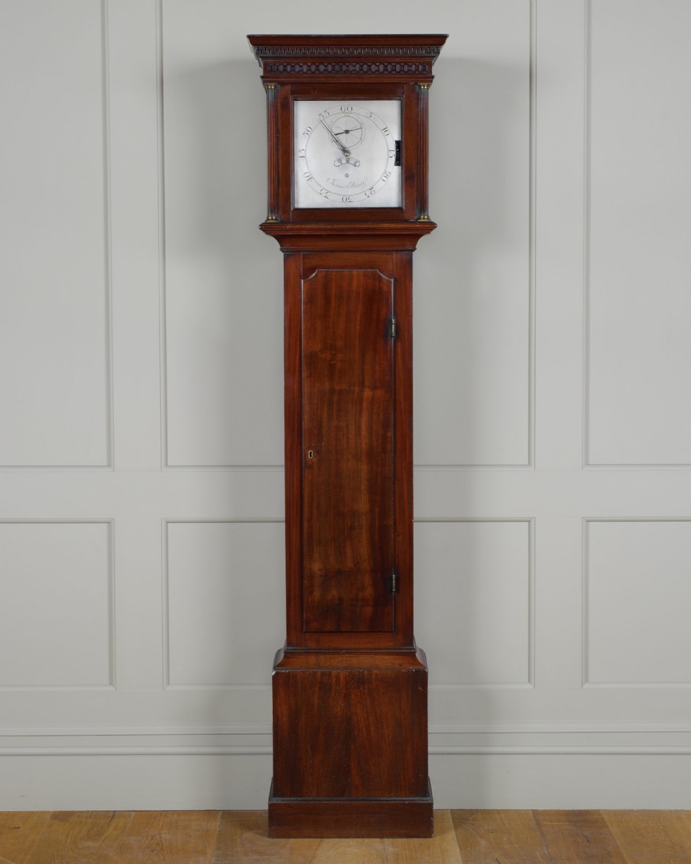 An 18th-century Georgian mahogany regulator longcase clock featuring a square glazed hood, silvered dial, and full-length trunk door.