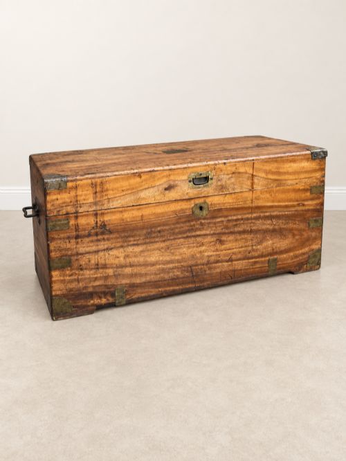 fig 1. A 19th-century rectangular wooden campaign chest featuring protective brass corner brackets, flush carrying handles, and a hinged lid.