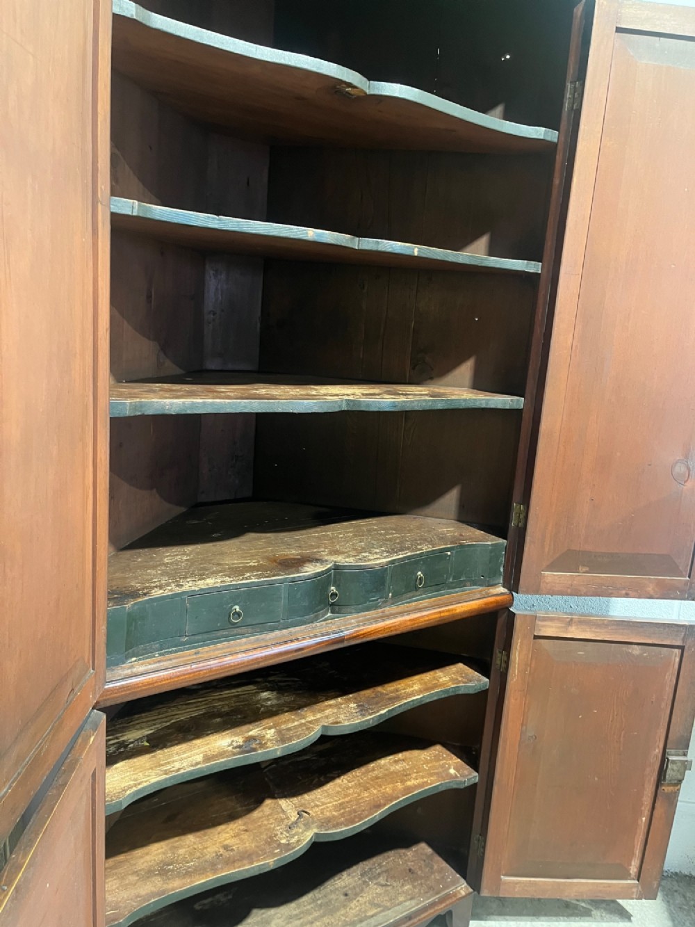 A tall Georgian floor-standing corner cupboard made of dark flame mahogany, featuring two upper doors and two lower doors with brass diamond escutcheons. View XI