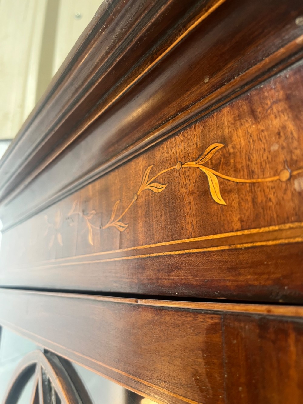 A 19th-century floor-standing mahogany corner cupboard featuring a glazed upper door with oval astragal glazing and an inlaid lower cabinet door. View VI