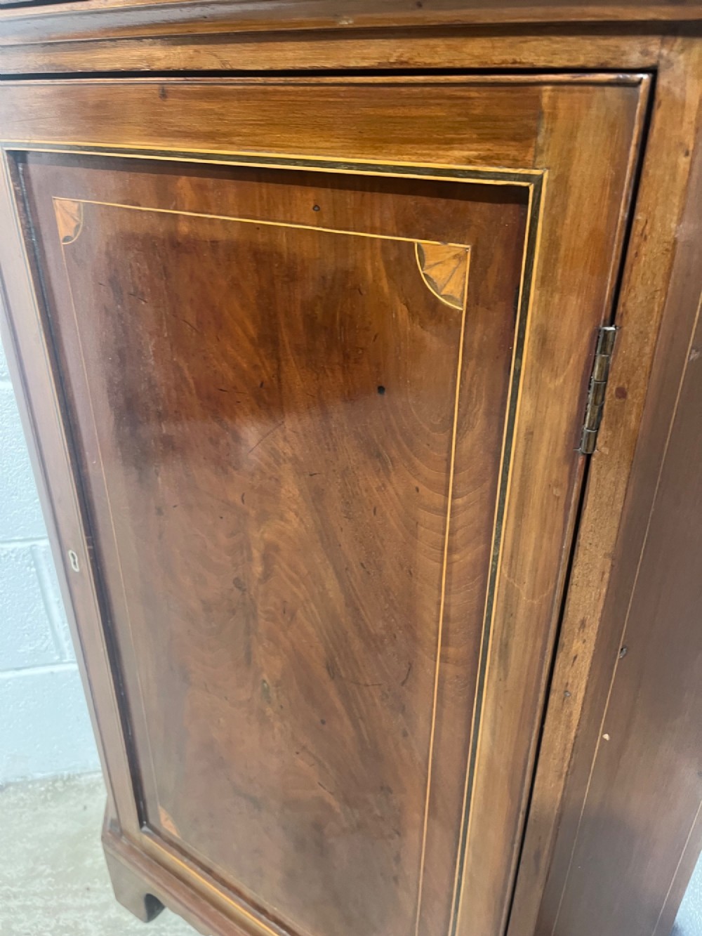 A 19th-century floor-standing mahogany corner cupboard featuring a glazed upper door with oval astragal glazing and an inlaid lower cabinet door. View VIII