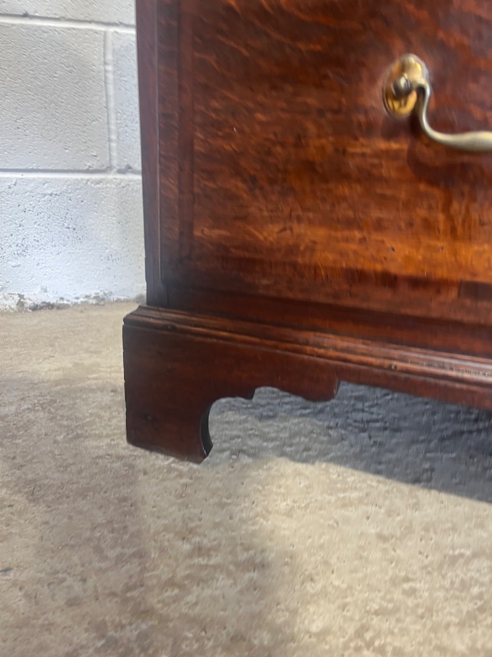A tall George III oak chest on chest featuring brass swan-neck handles, crossbanded drawer borders, and bracket feet. View XI