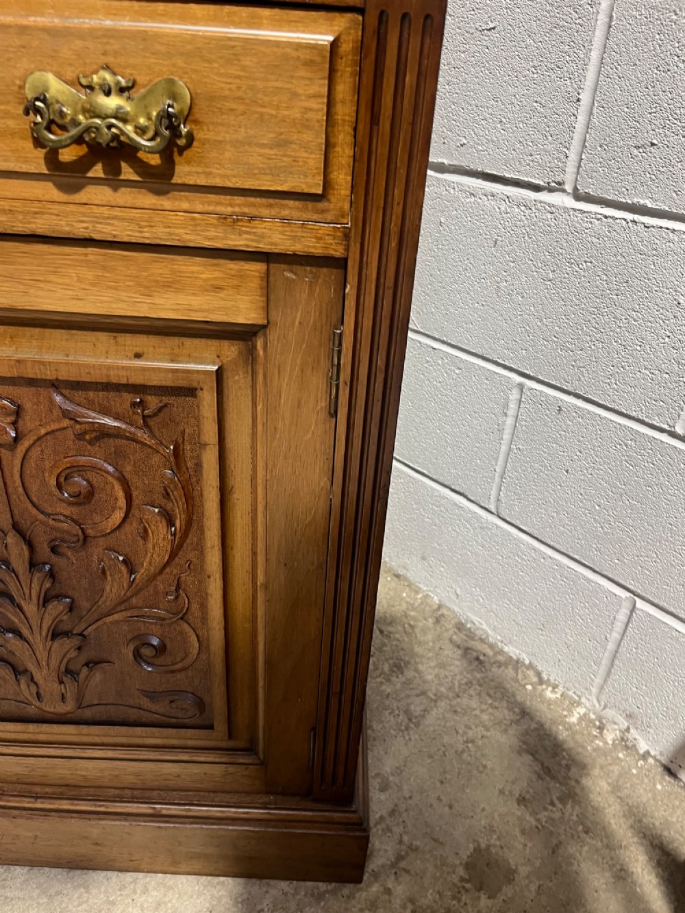 A 19th-century mahogany glazed bookcase featuring upper double glass doors filled with books, middle drawers, and lower doors with carved foliate panels. View VIII