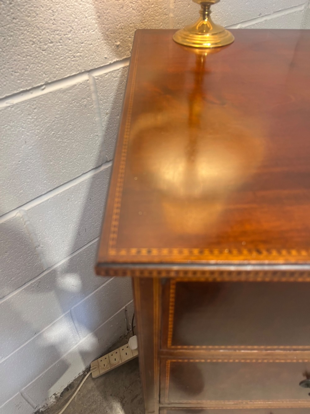 A late 19th-century mahogany chest of drawers featuring two short upper drawers over four long drawers, detailed with satinwood stringing and brass handles. View VII