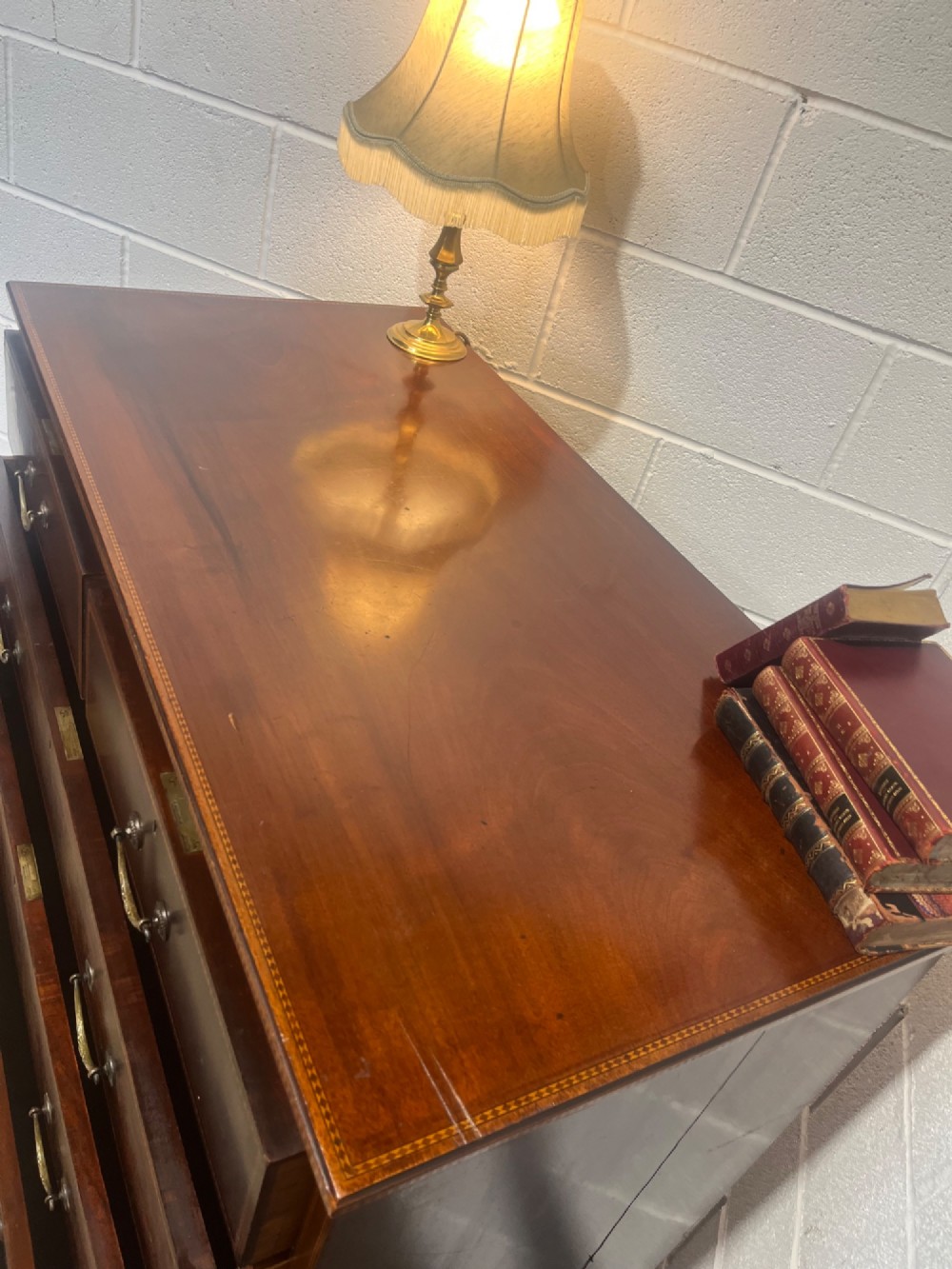 A late 19th-century mahogany chest of drawers featuring two short upper drawers over four long drawers, detailed with satinwood stringing and brass handles. View XIV