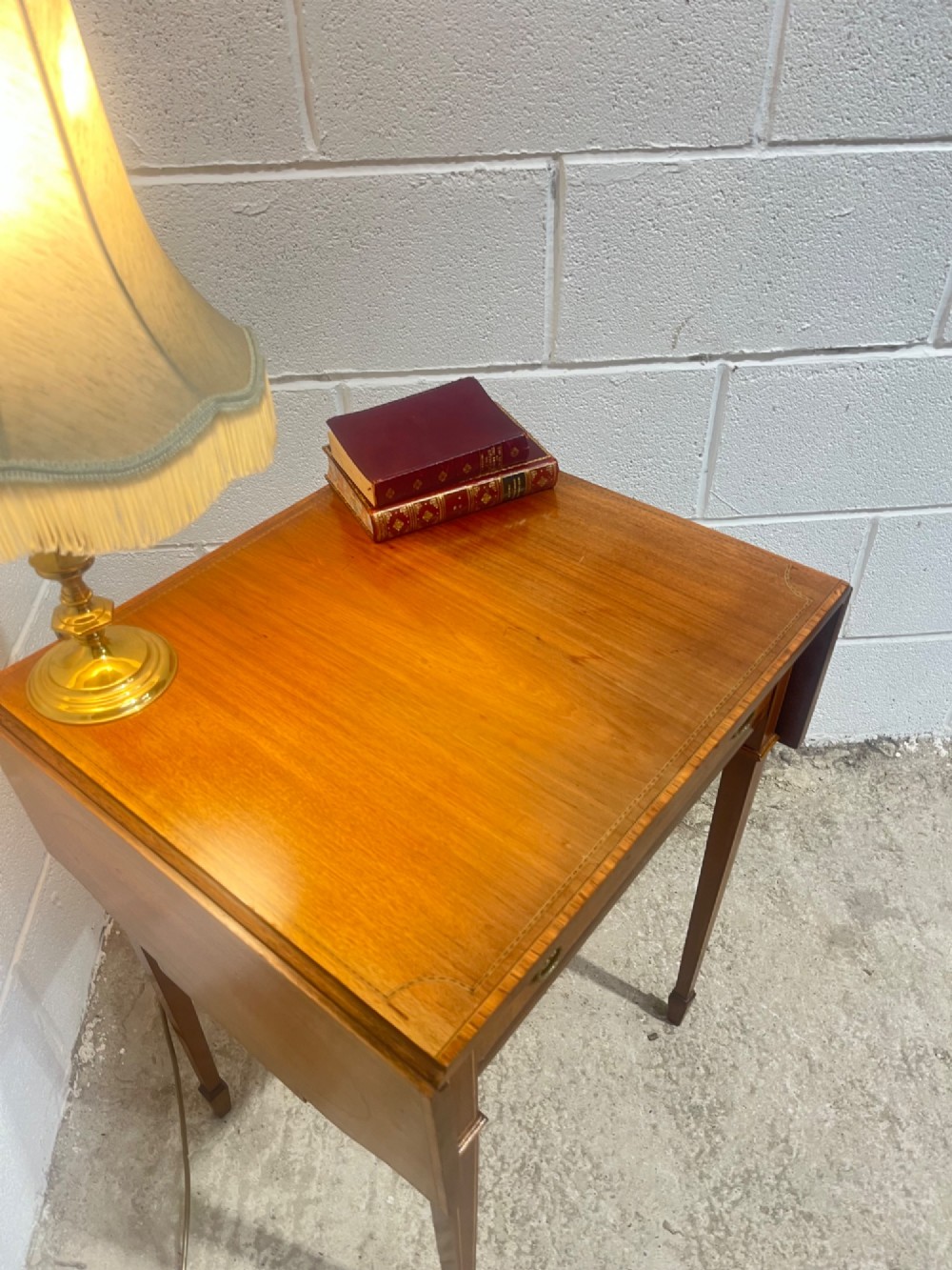 A 19th-century mahogany side table featuring two hinged drop leaves, a single frieze drawer with dual brass ring handles, boxwood line inlay, and four square tapered legs. View III