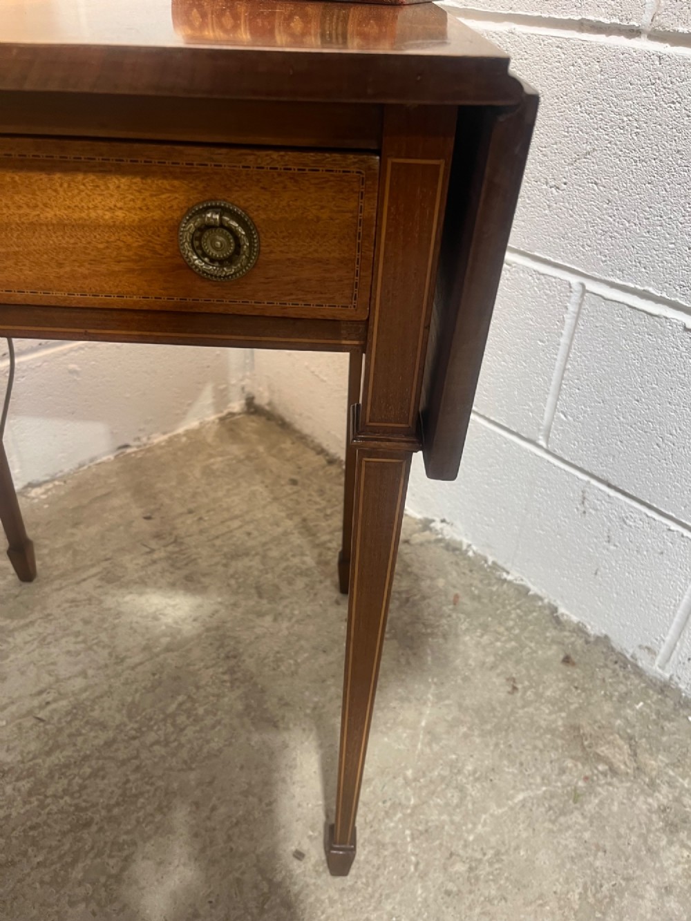 A 19th-century mahogany side table featuring two hinged drop leaves, a single frieze drawer with dual brass ring handles, boxwood line inlay, and four square tapered legs. View IX