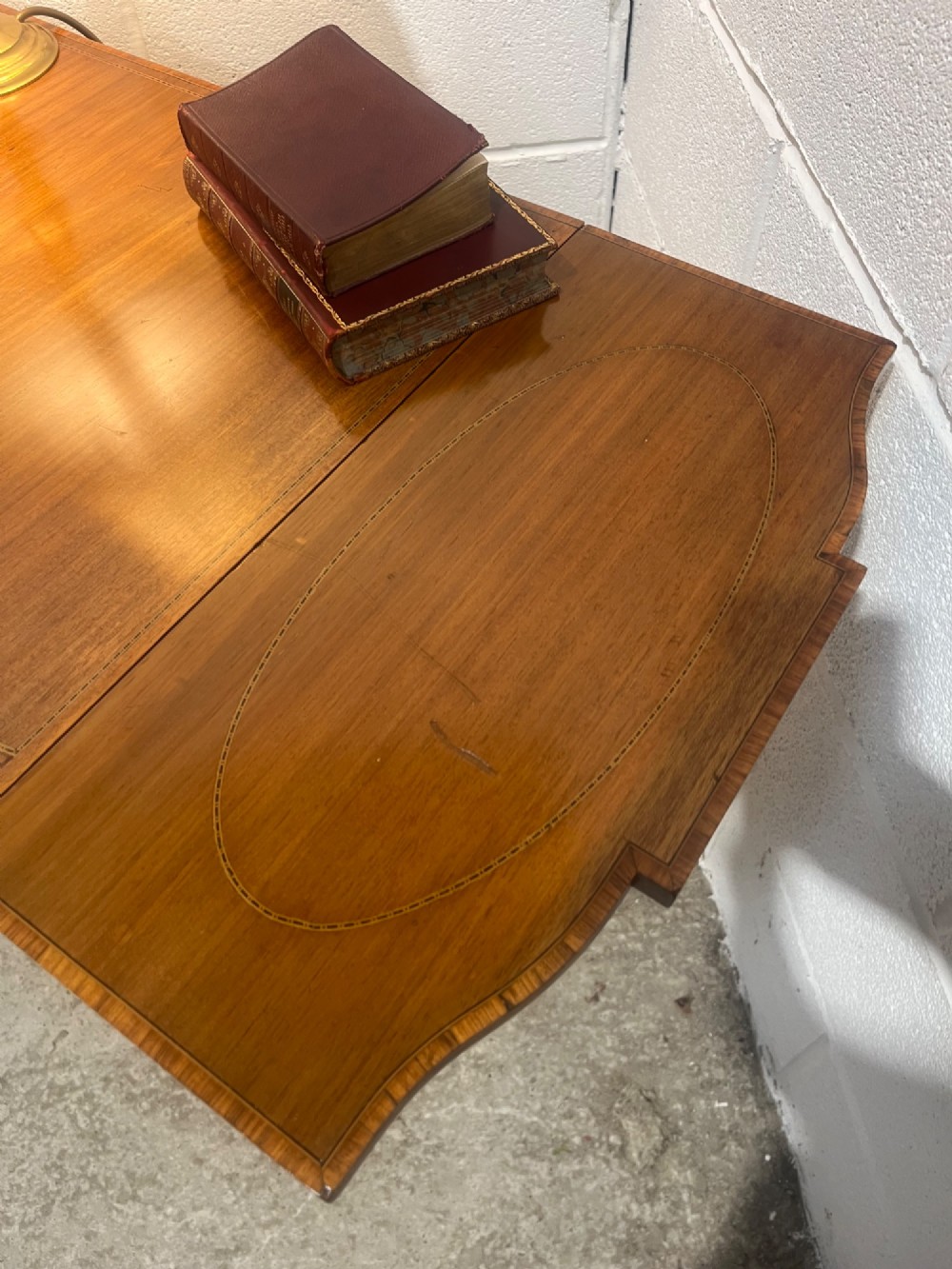 A 19th-century mahogany side table featuring two hinged drop leaves, a single frieze drawer with dual brass ring handles, boxwood line inlay, and four square tapered legs. View XI