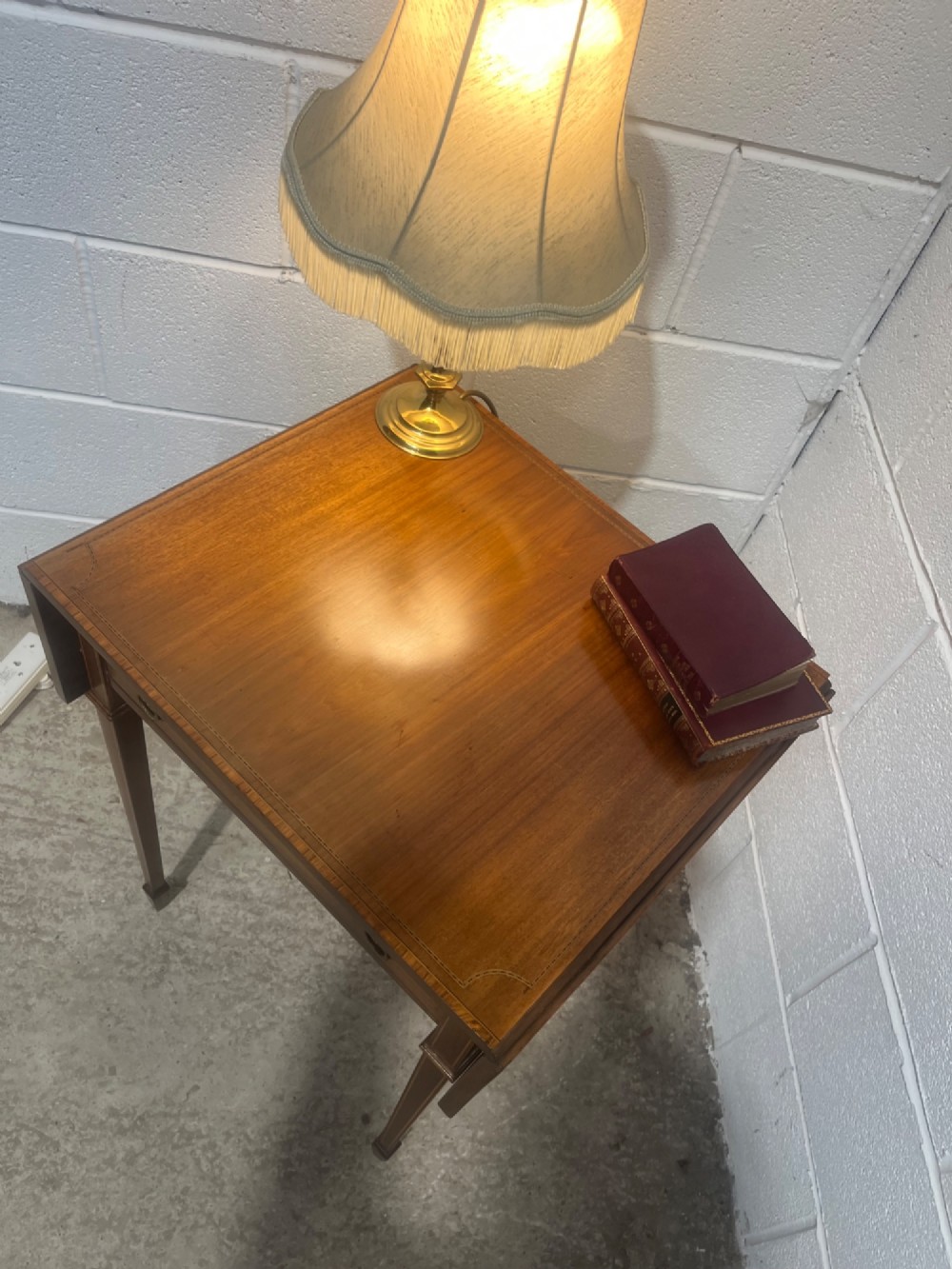 A 19th-century mahogany side table featuring two hinged drop leaves, a single frieze drawer with dual brass ring handles, boxwood line inlay, and four square tapered legs. View XII