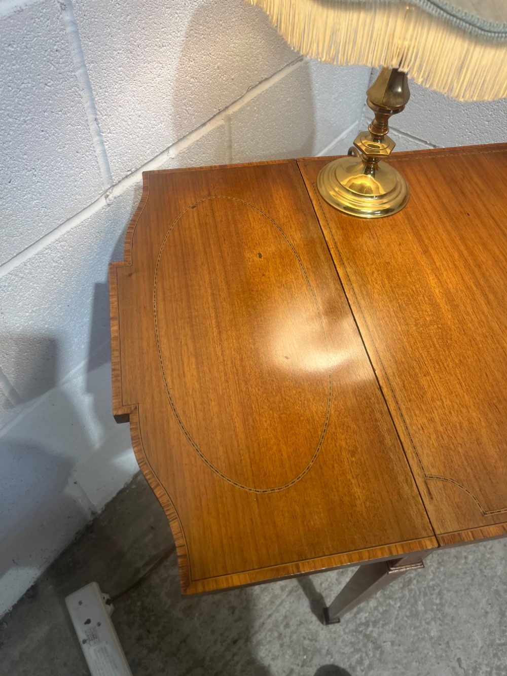 A 19th-century mahogany side table featuring two hinged drop leaves, a single frieze drawer with dual brass ring handles, boxwood line inlay, and four square tapered legs. View XIII