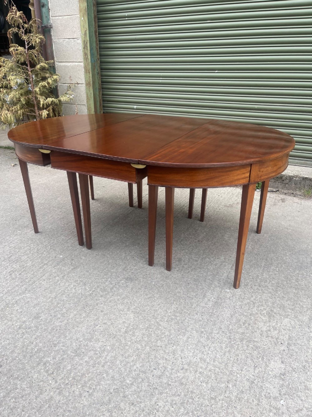 An extended 19th-century mahogany D-end dining table supported by multiple square tapered legs. View III