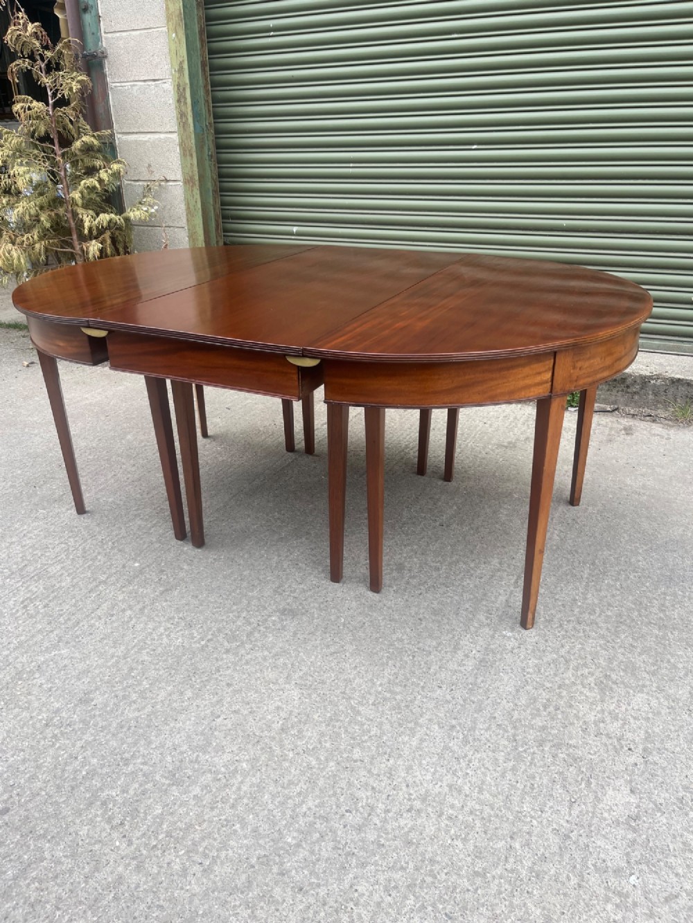 An extended 19th-century mahogany D-end dining table supported by multiple square tapered legs. View VII