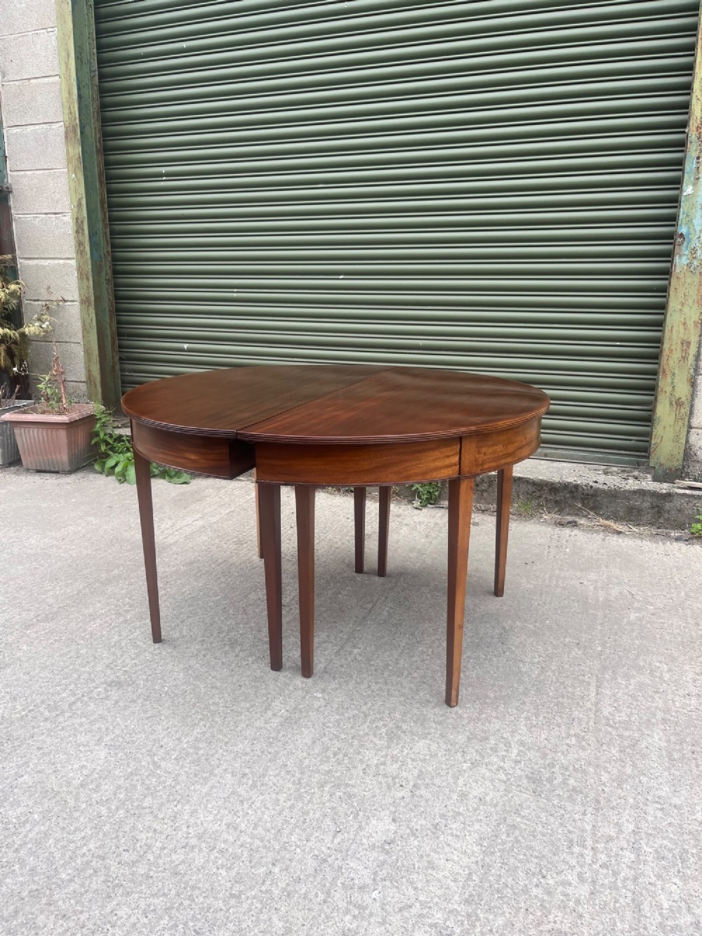 An extended 19th-century mahogany D-end dining table supported by multiple square tapered legs. View XII